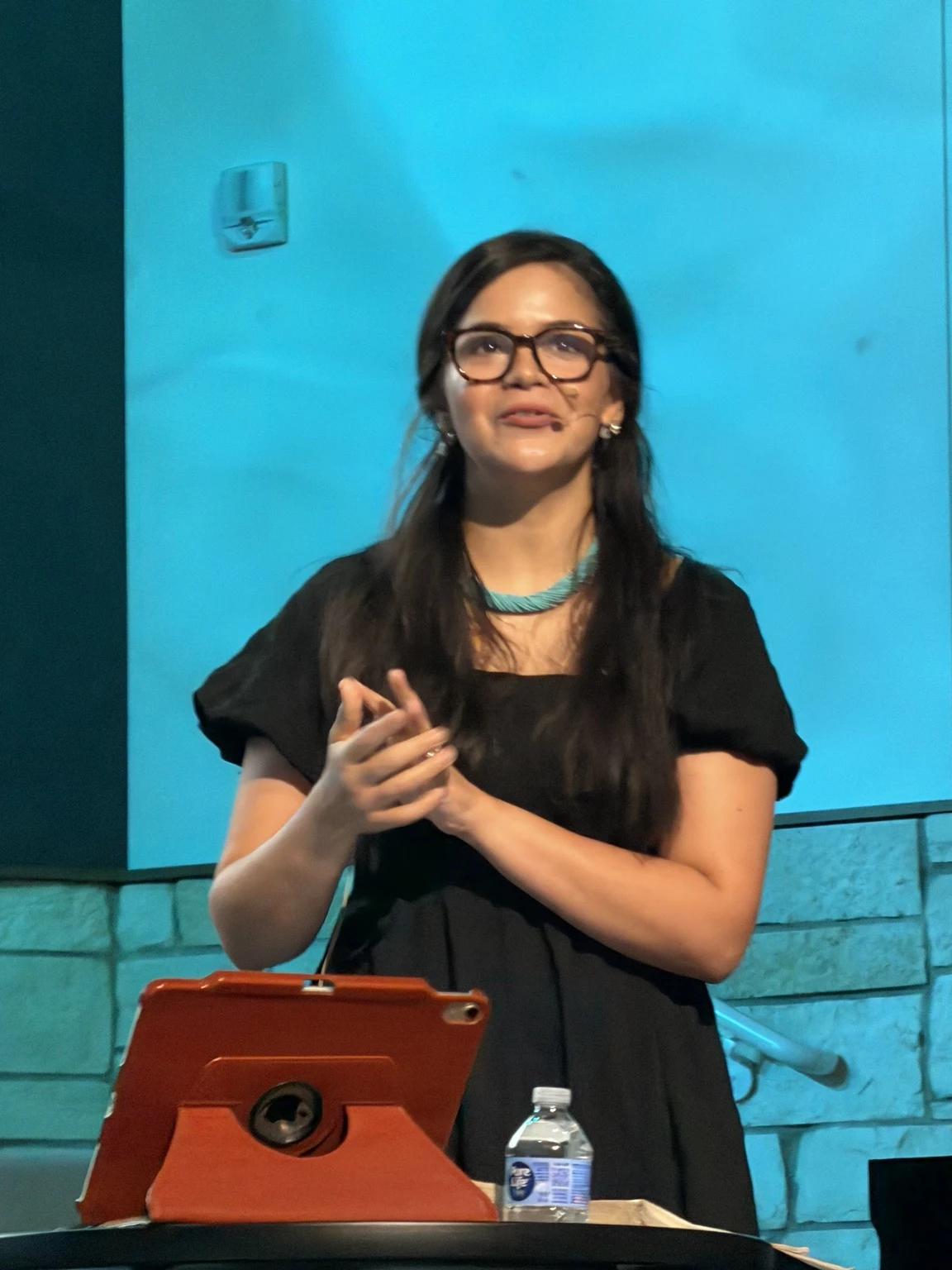 A woman sharing a reflection at church