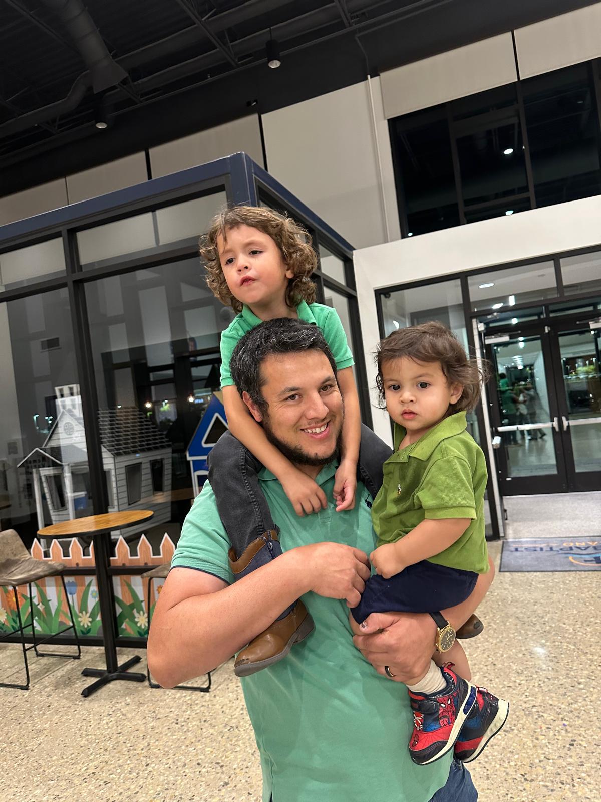 A man and two children spending time together at church